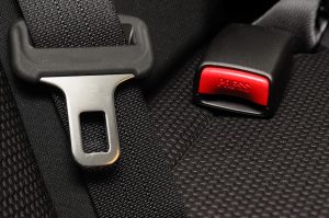 Insert molding process serves in making safety belt buckle system